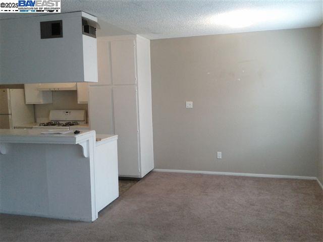 Pleasanton Pleasanton, CA 94588 - Photo 6 of 17 a kitchen with cabinets and white appliances