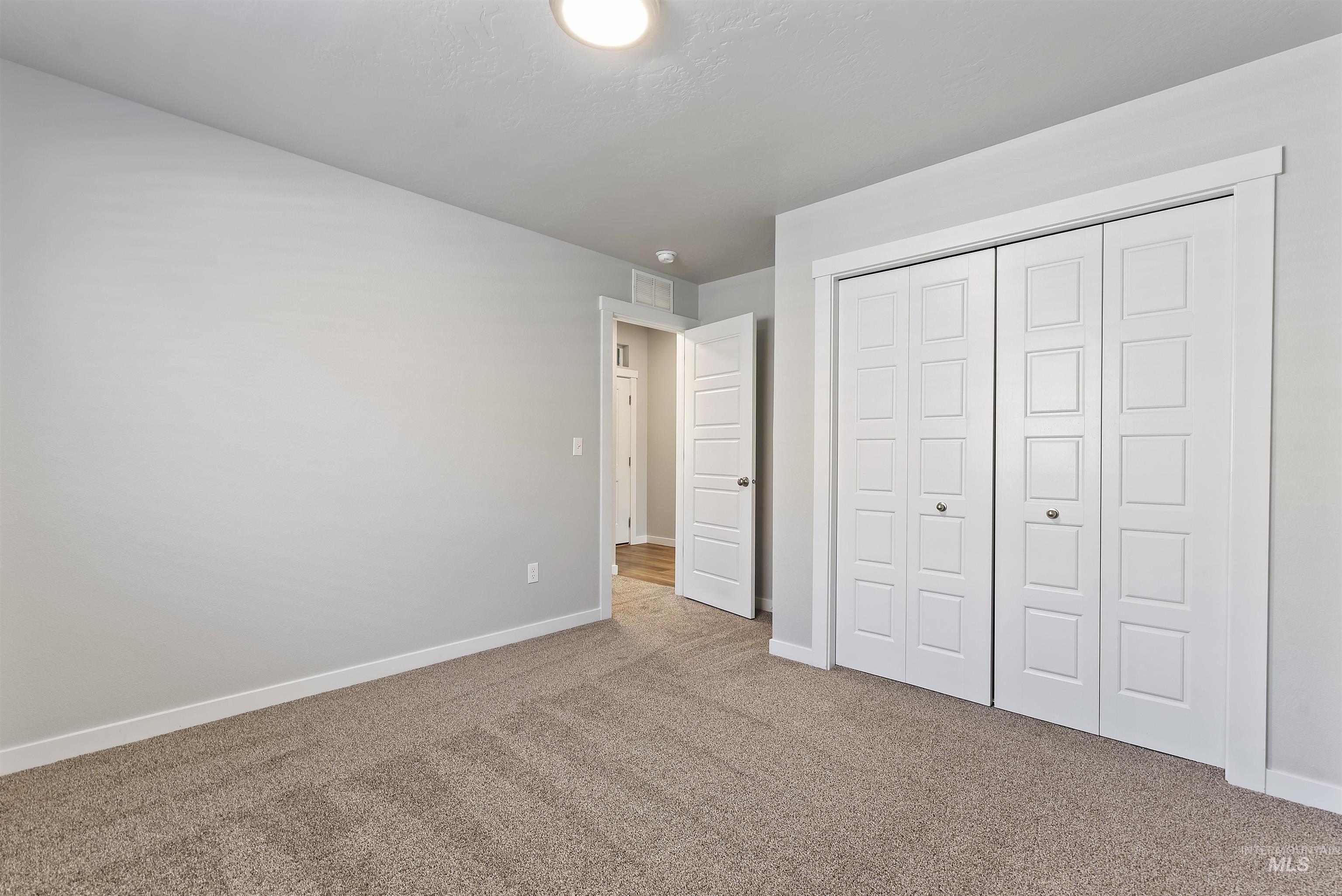 12703 West Fig Street Boise, ID 83713 - Photo 13 of 26 Unfurnished bedroom with carpet and a closet