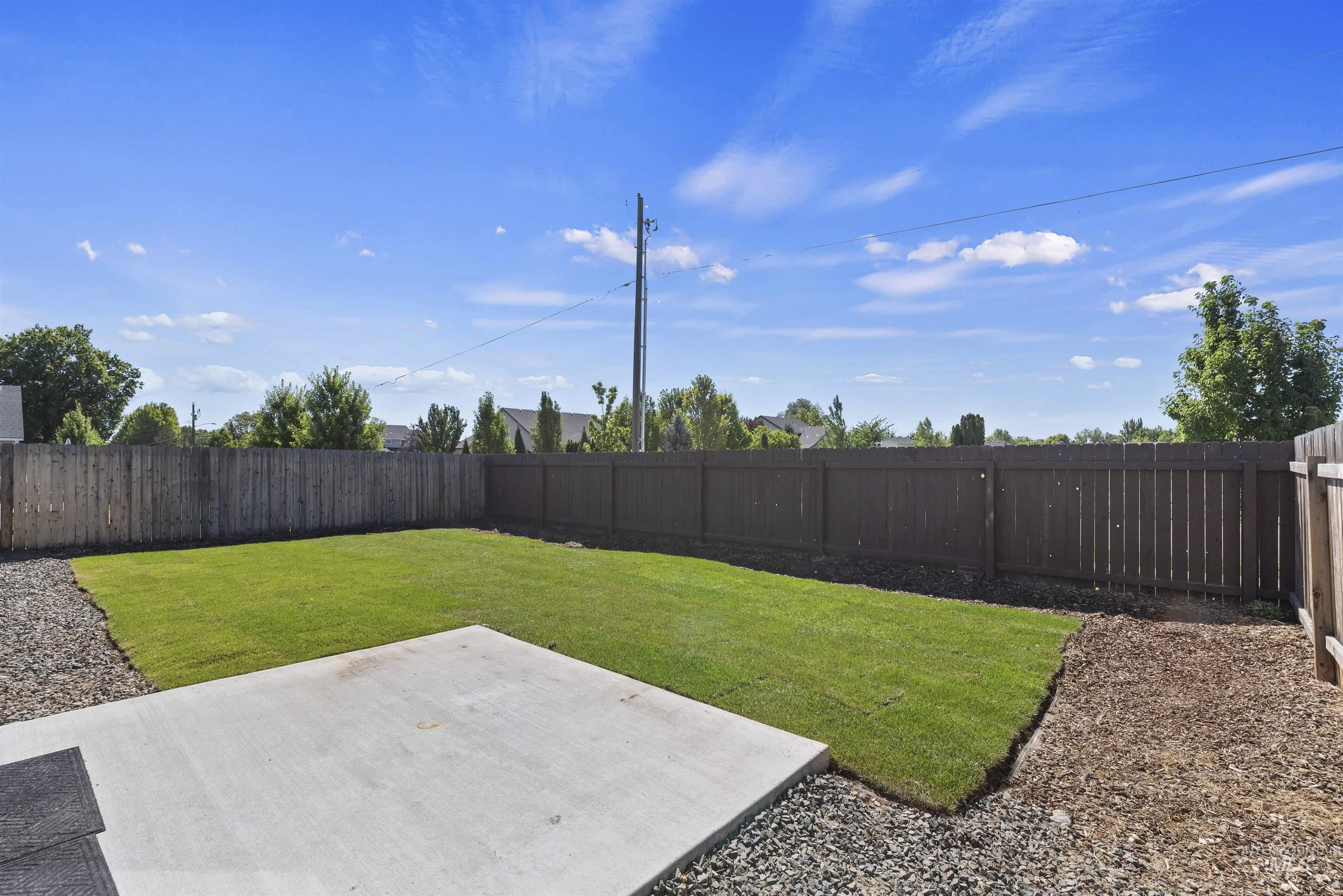 12703 West Fig Street Boise, ID 83713 - Photo 22 of 26 Fenced backyard with a patio area