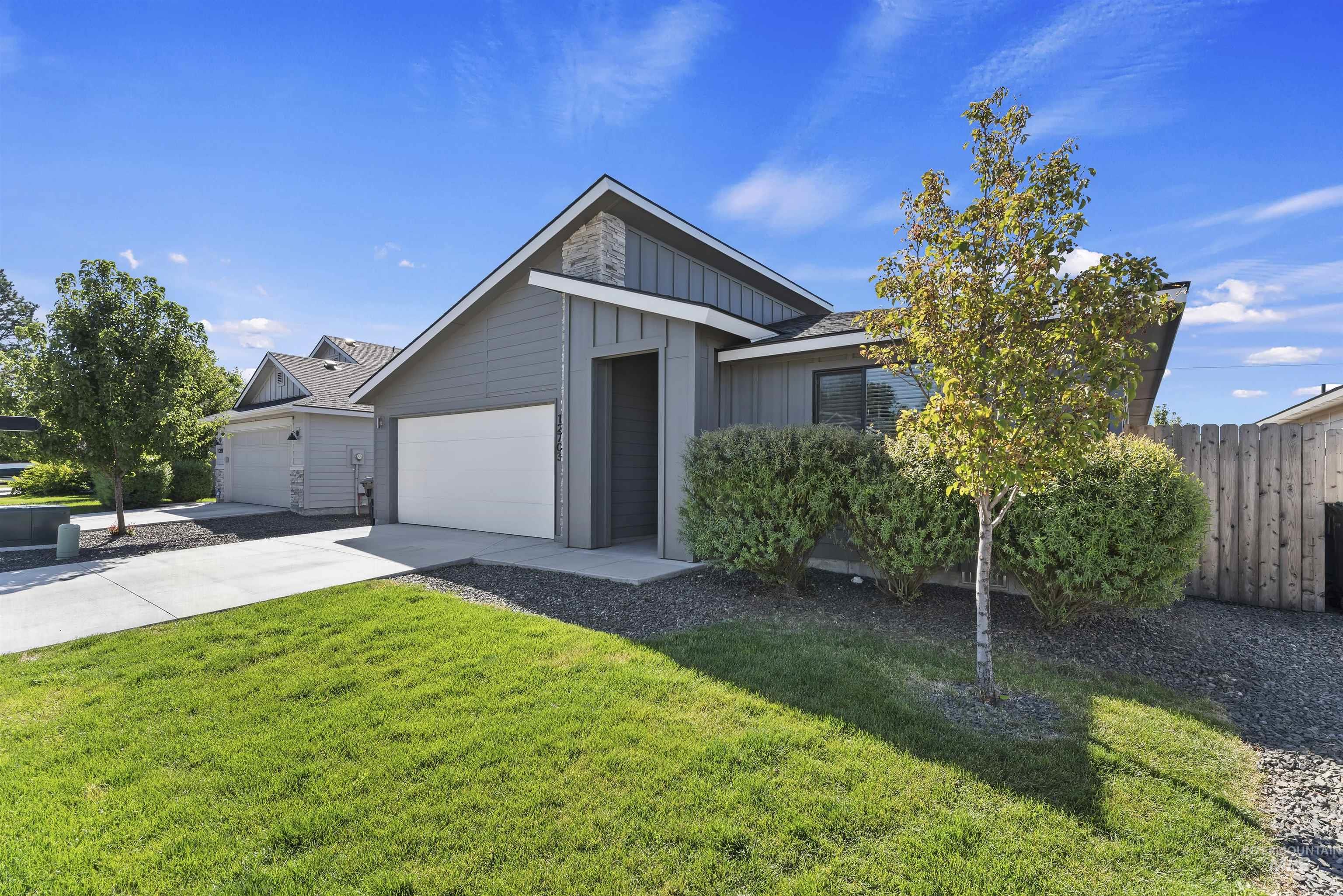12703 West Fig Street Boise, ID 83713 - Photo 3 of 26 View of front facade featuring board and batten siding, concrete driveway, and a garage