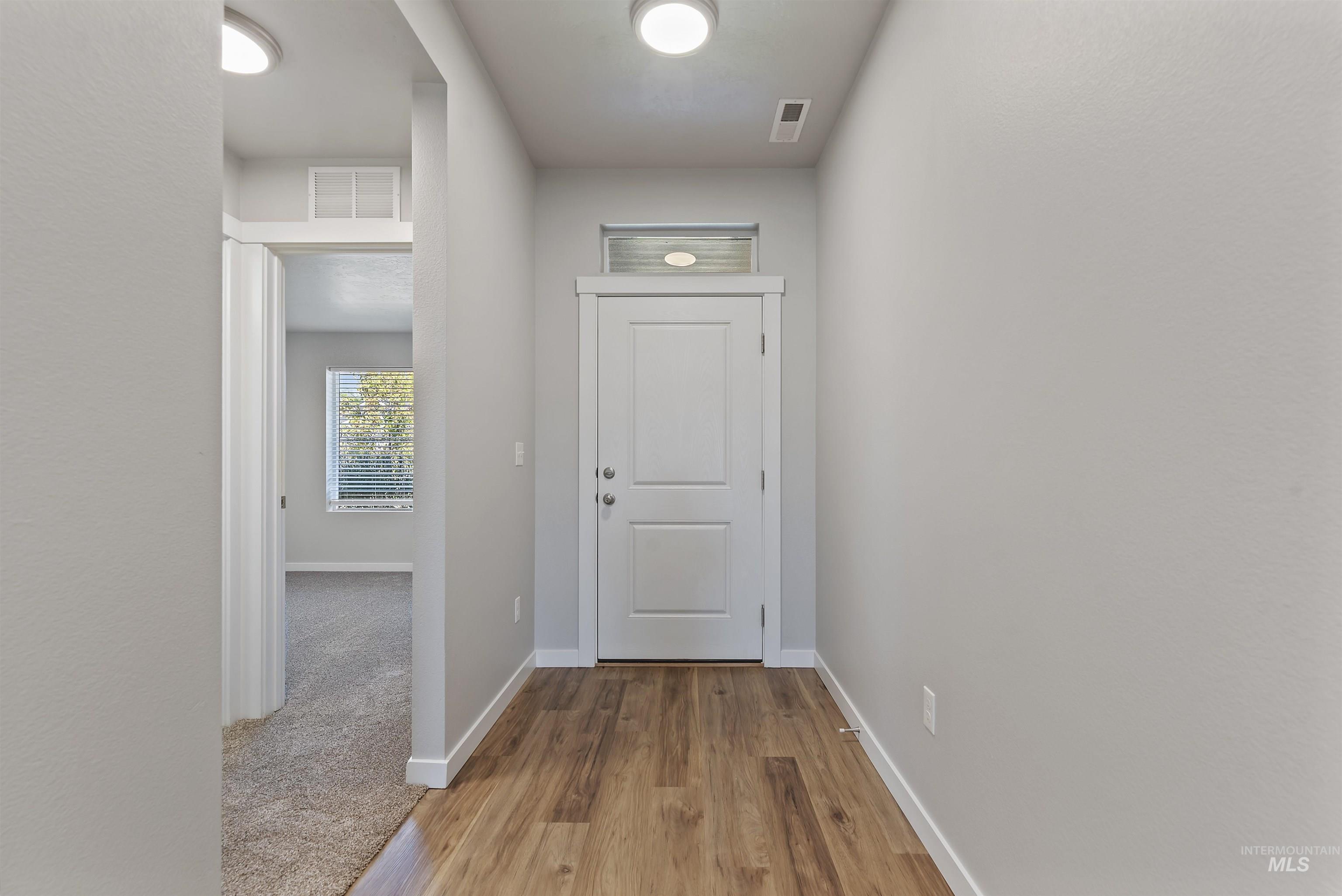 12703 West Fig Street Boise, ID 83713 - Photo 4 of 26 Entryway with baseboards and wood finished floors