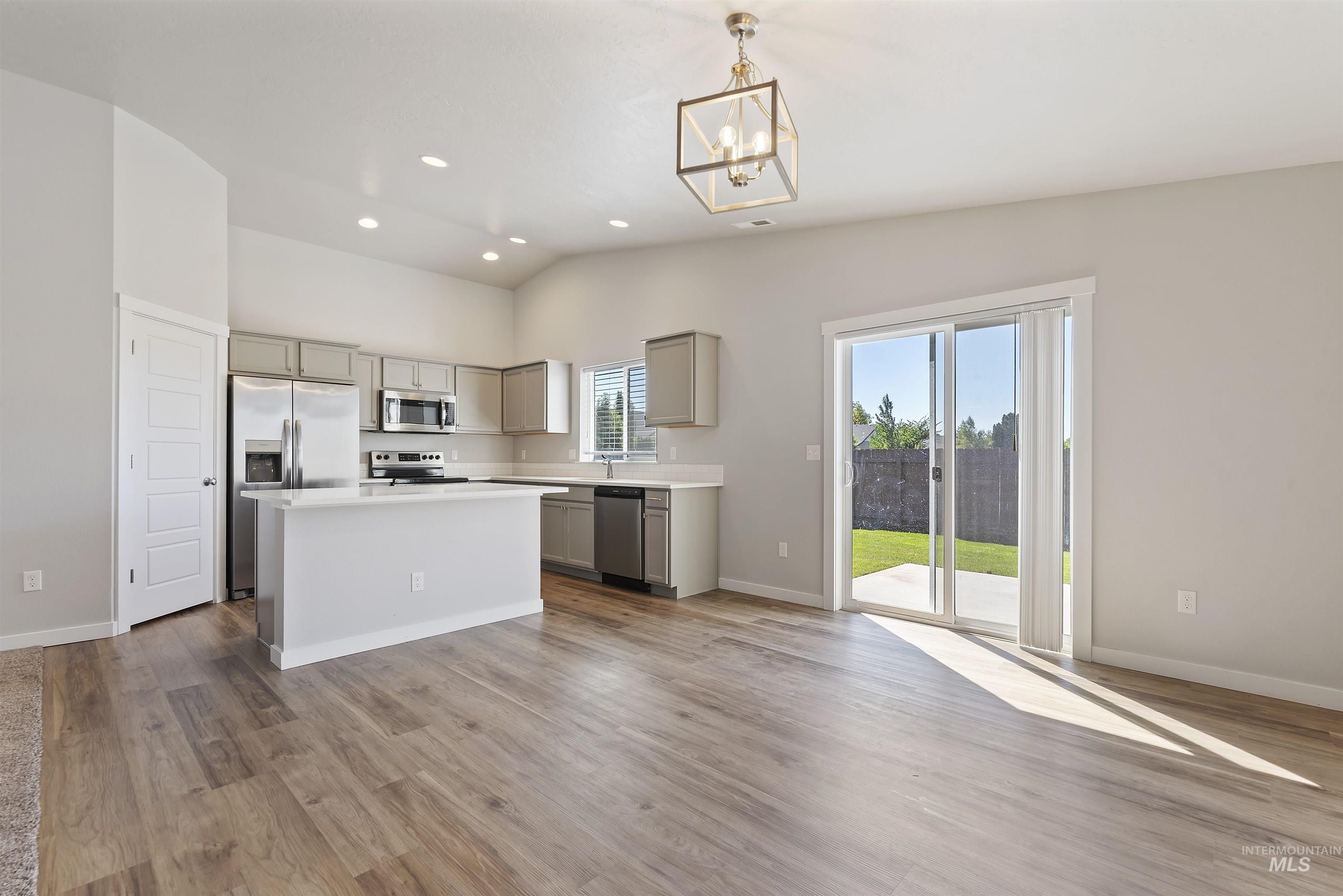 12703 West Fig Street Boise, ID 83713 - Photo 9 of 26 Kitchen featuring gray cabinets, a kitchen island, light countertops, stainless steel appliances, and recessed lighting