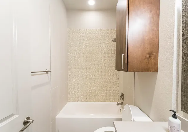 a bathroom with a bathtub and shower