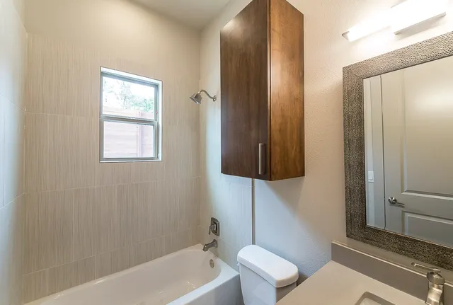 a bathroom with a toilet a sink and bathtub