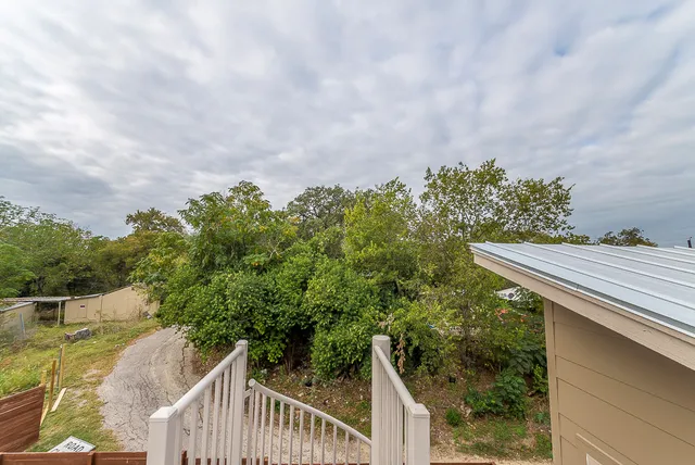 a balcony with trees in front of it