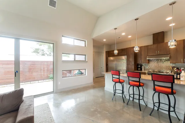 a kitchen with stainless steel appliances kitchen island granite top and refrigerator