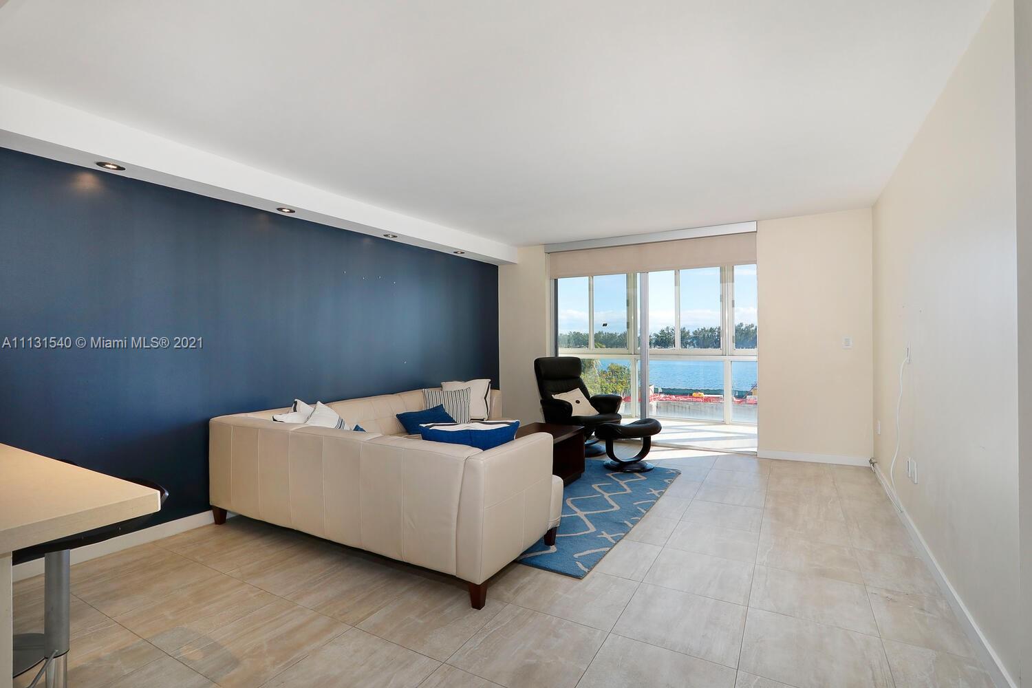 145 Southeast 25th Road, Unit 502 Miami, FL 33129 - Photo 6 of 24 a living room with furniture and large windows