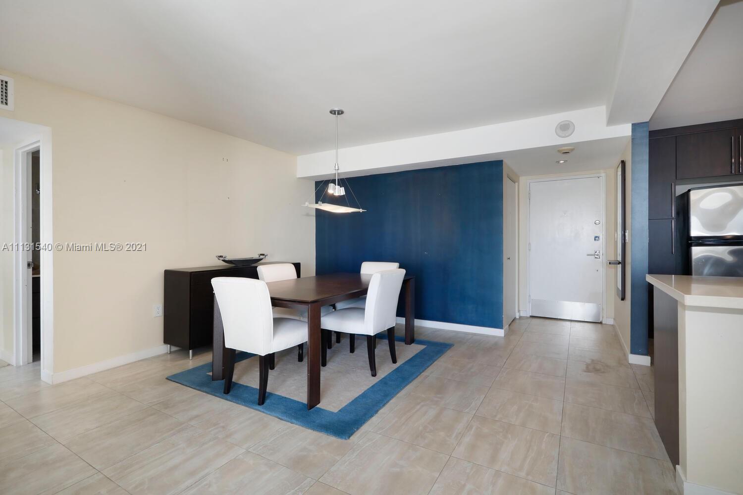 145 Southeast 25th Road, Unit 502 Miami, FL 33129 - Photo 10 of 24 a view of a dining room with furniture and a rug