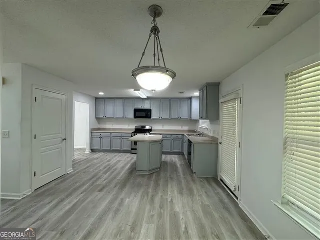 a kitchen with a sink stainless steel appliances and cabinets