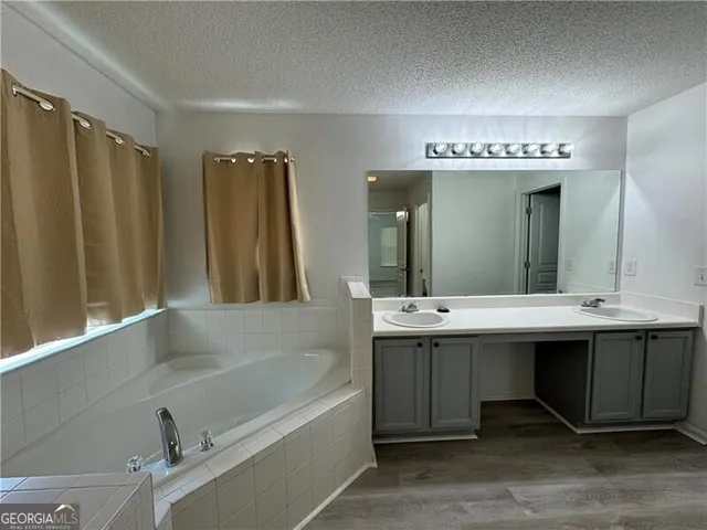 a bathroom with a double vanity sink and mirror