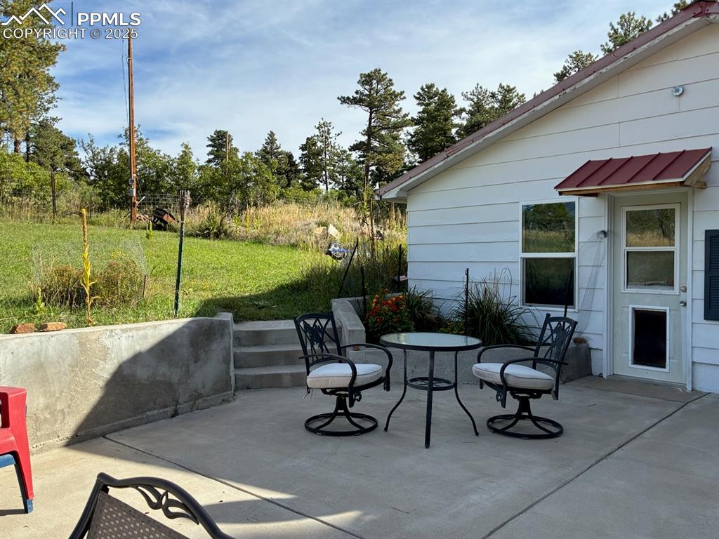 8201 Old San Isabel Road Rye, CO 81069 - Photo 26 of 30 a view of a patio with table and chairs potted plants and a large tree