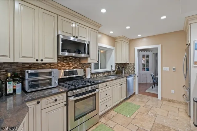 a kitchen with stainless steel appliances granite countertop a stove and a sink