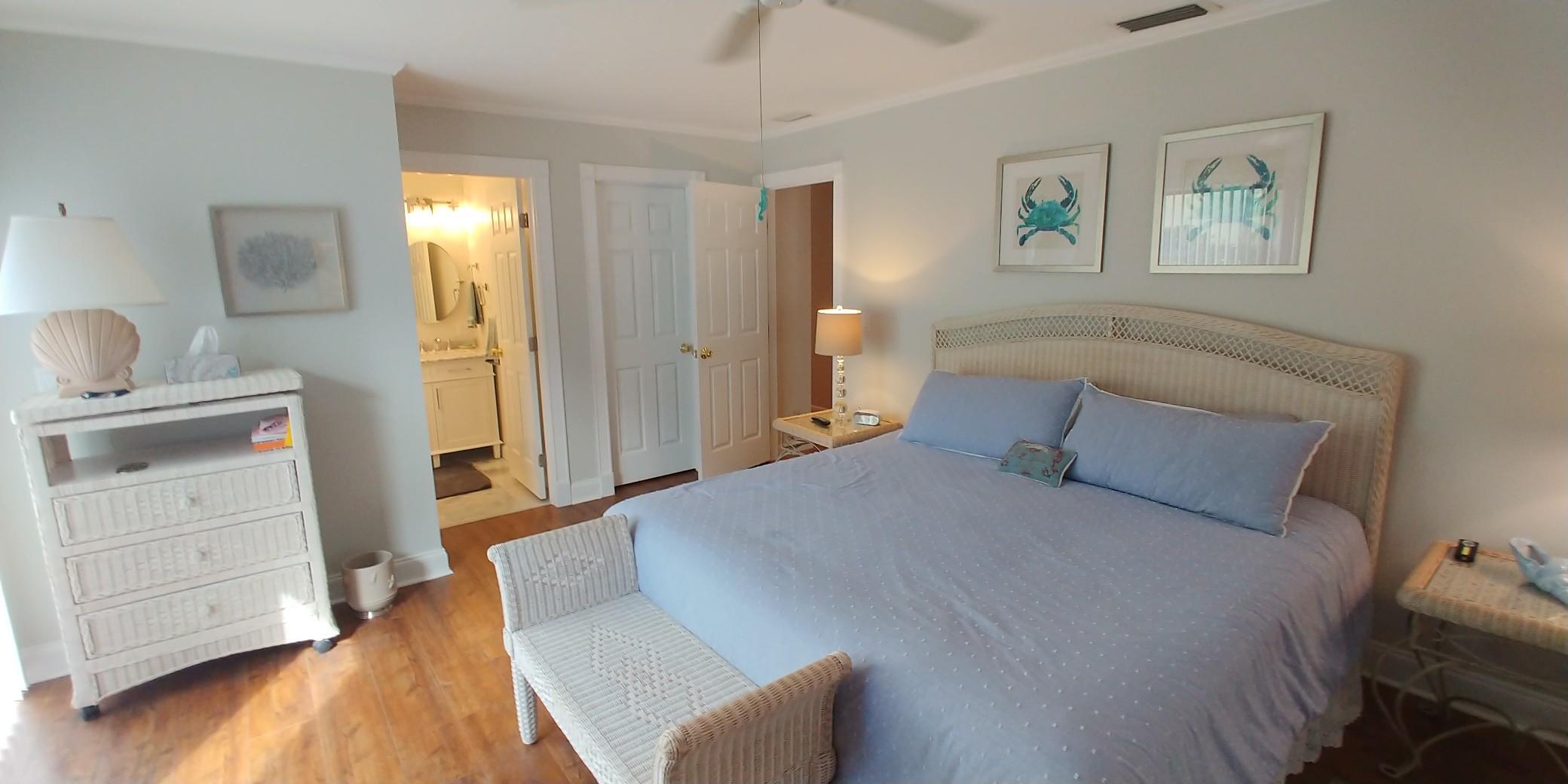 17042 Traverse Circle Jupiter, FL 33477 - Photo 21 of 30 a bedroom with a bed and wooden floor