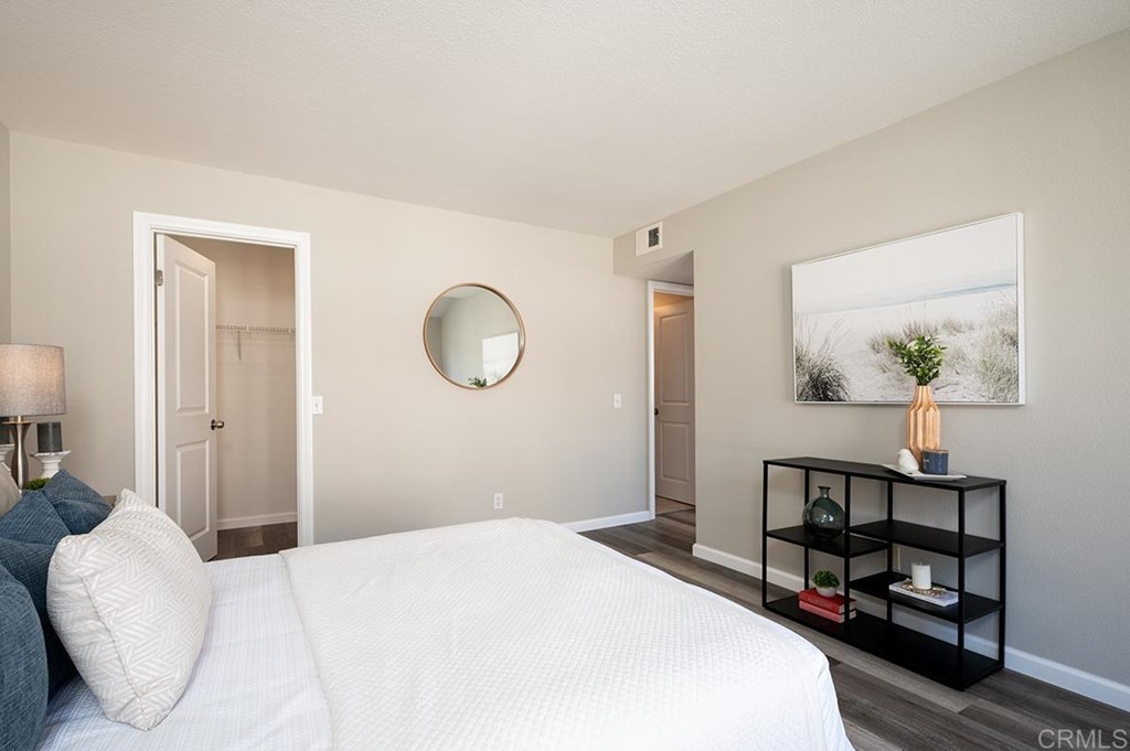 1340 Serena Circle, Unit 1 Chula Vista, CA 91910 - Photo 17 of 31 a bedroom with a bed and a lamp on table