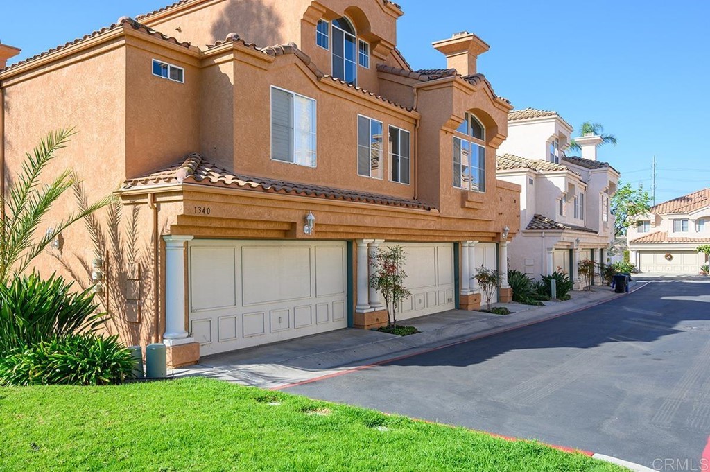 1340 Serena Circle, Unit 1 Chula Vista, CA 91910 - Photo 3 of 31 a front view of a house with a garden and plants