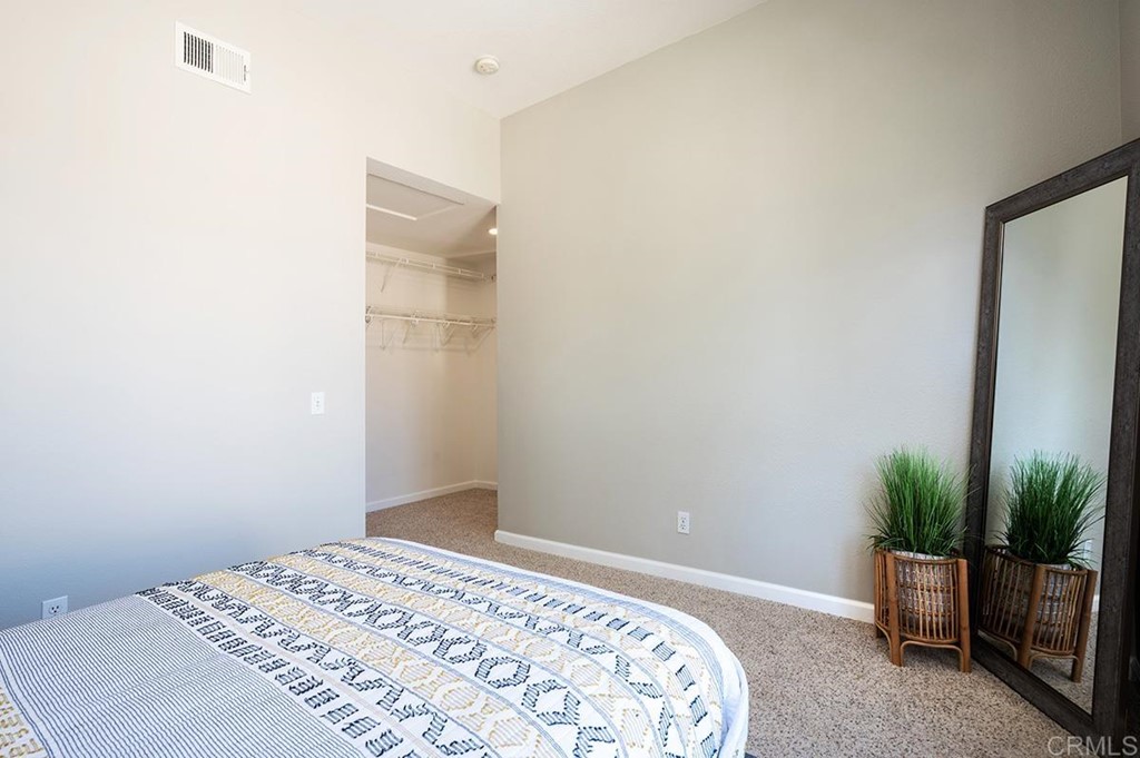 1340 Serena Circle, Unit 1 Chula Vista, CA 91910 - Photo 21 of 31 a bedroom with a bed and a potted plant