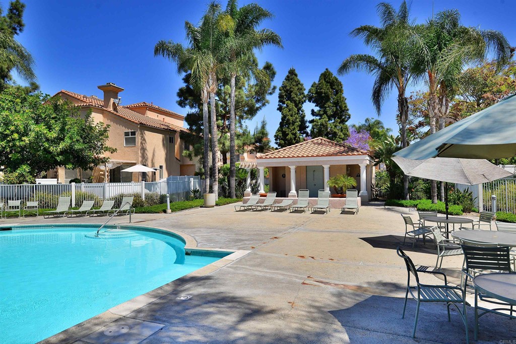 1340 Serena Circle, Unit 1 Chula Vista, CA 91910 - Photo 31 of 31 a view of a swimming pool with lawn chairs under an umbrella