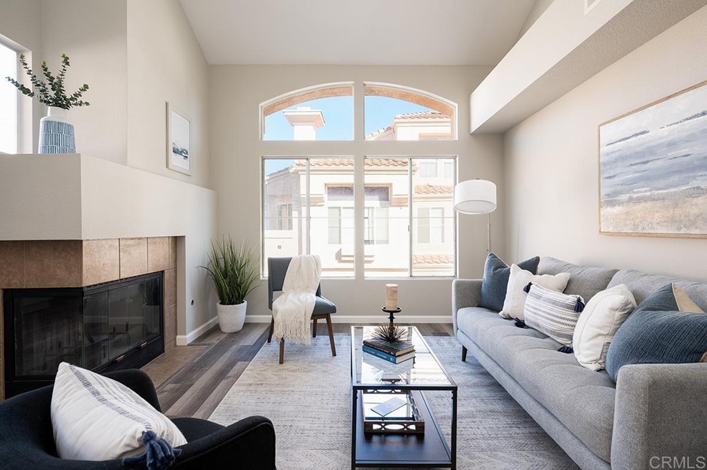 1340 Serena Circle, Unit 1 Chula Vista, CA 91910 - Photo 8 of 31 a living room with furniture a fireplace and a large window