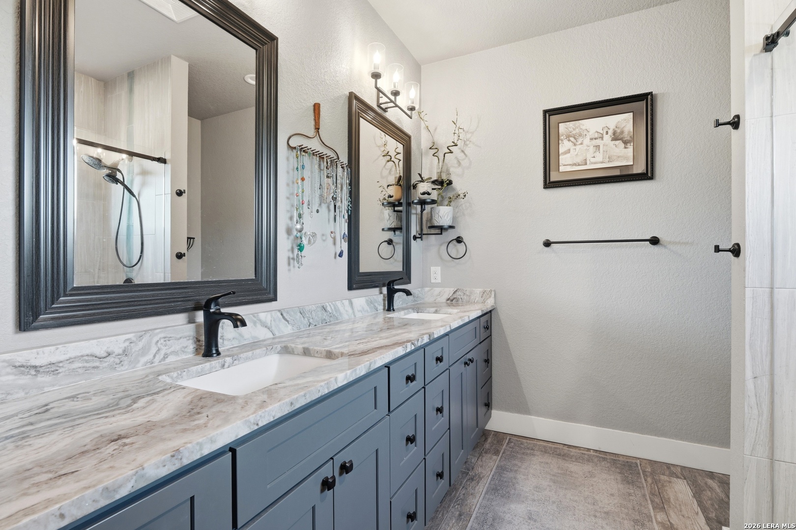 2295 Tanglewood Trail Spring Branch, TX 78070 - Photo 15 of 37 a bathroom with a double vanity sink and a mirror