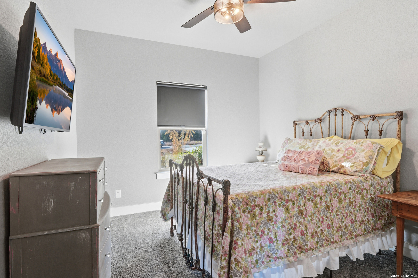 2295 Tanglewood Trail Spring Branch, TX 78070 - Photo 17 of 37 a bedroom with a bed and a chandelier