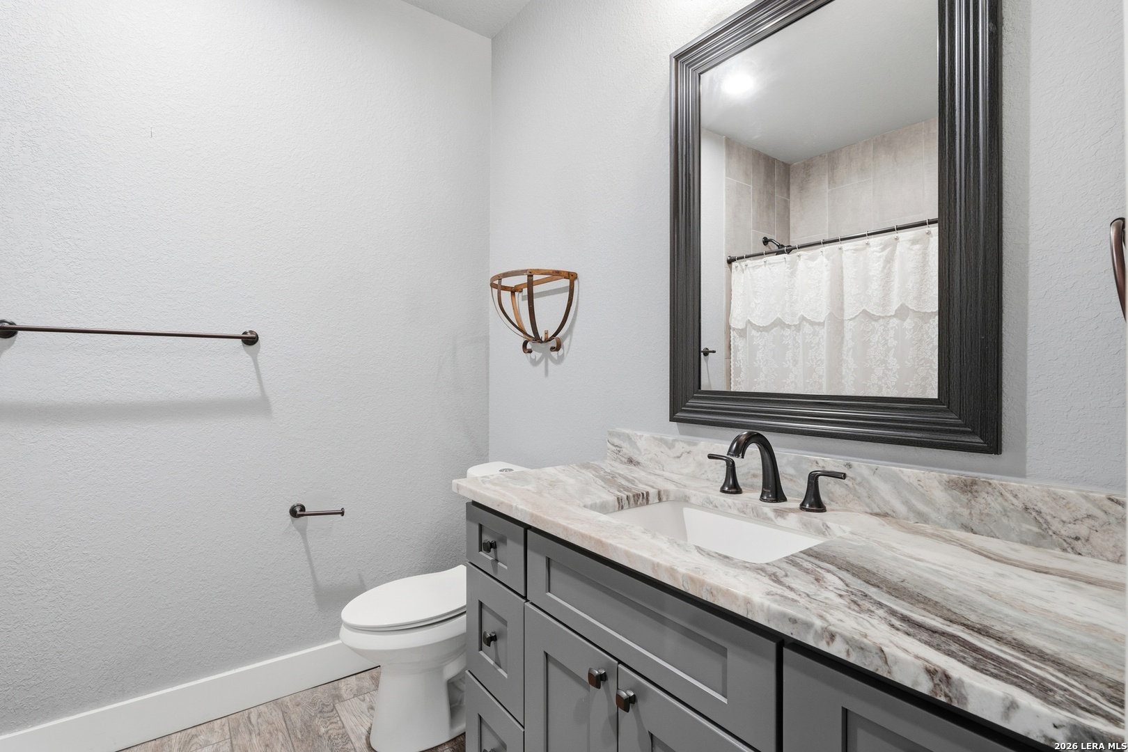 2295 Tanglewood Trail Spring Branch, TX 78070 - Photo 18 of 37 a bathroom with a granite countertop sink a toilet and a mirror
