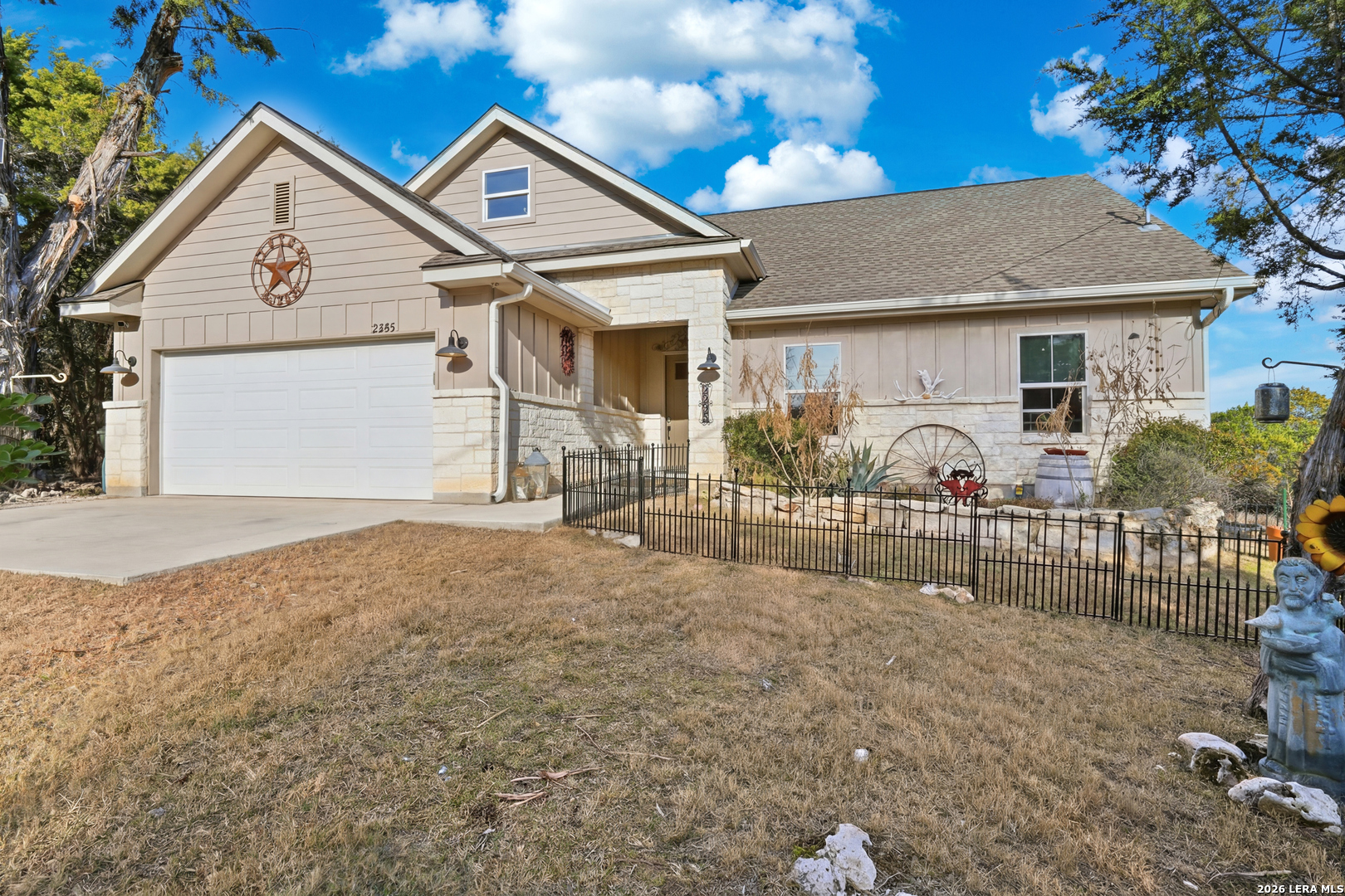 2295 Tanglewood Trail Spring Branch, TX 78070 - Photo 26 of 37 a view of a white house with iron fence