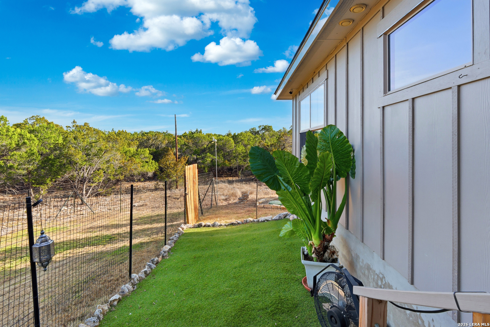 2295 Tanglewood Trail Spring Branch, TX 78070 - Photo 29 of 37 a view of a backyard with couches with wooden fence