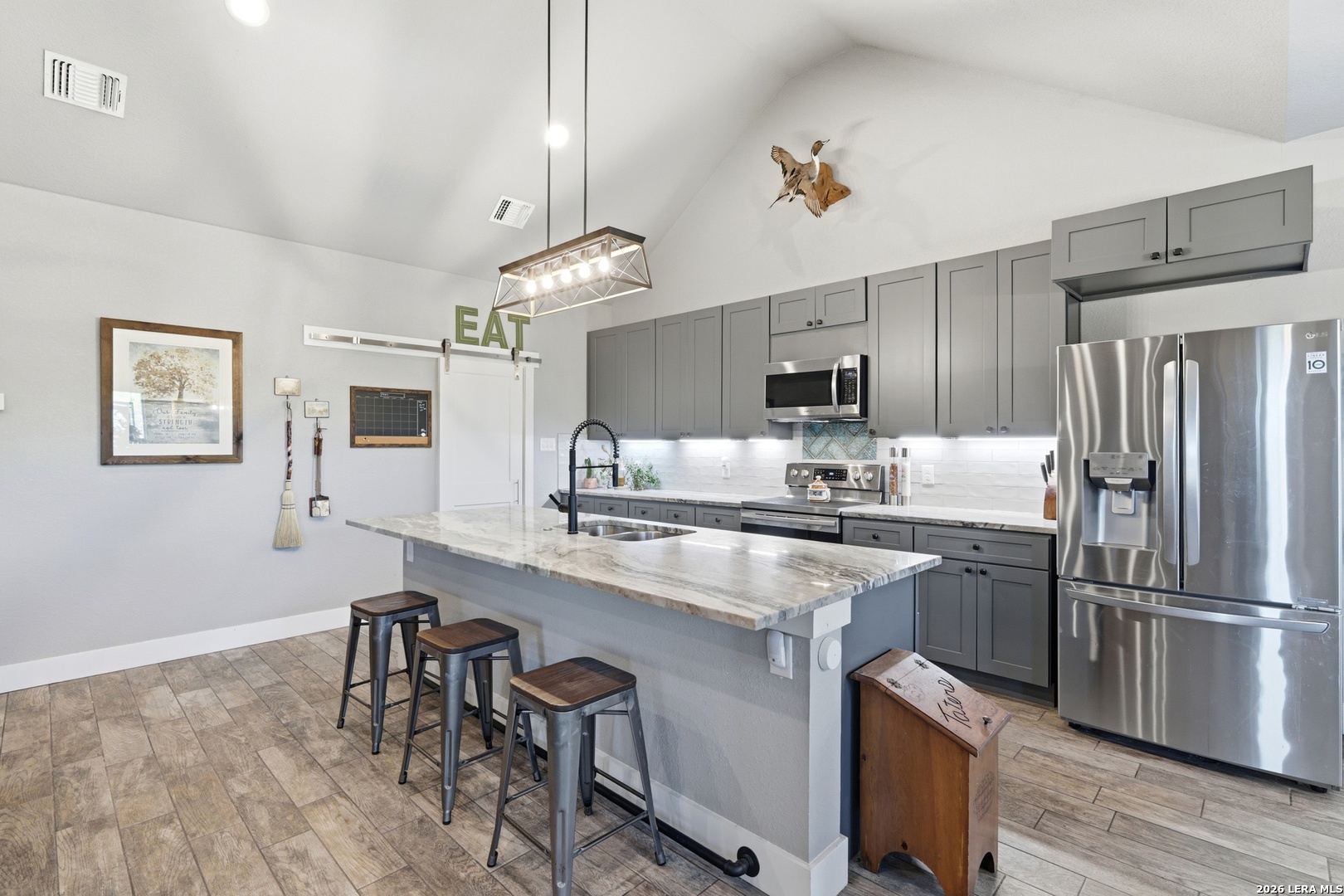 2295 Tanglewood Trail Spring Branch, TX 78070 - Photo 3 of 37 a kitchen with stainless steel appliances granite countertop a sink stove and refrigerator