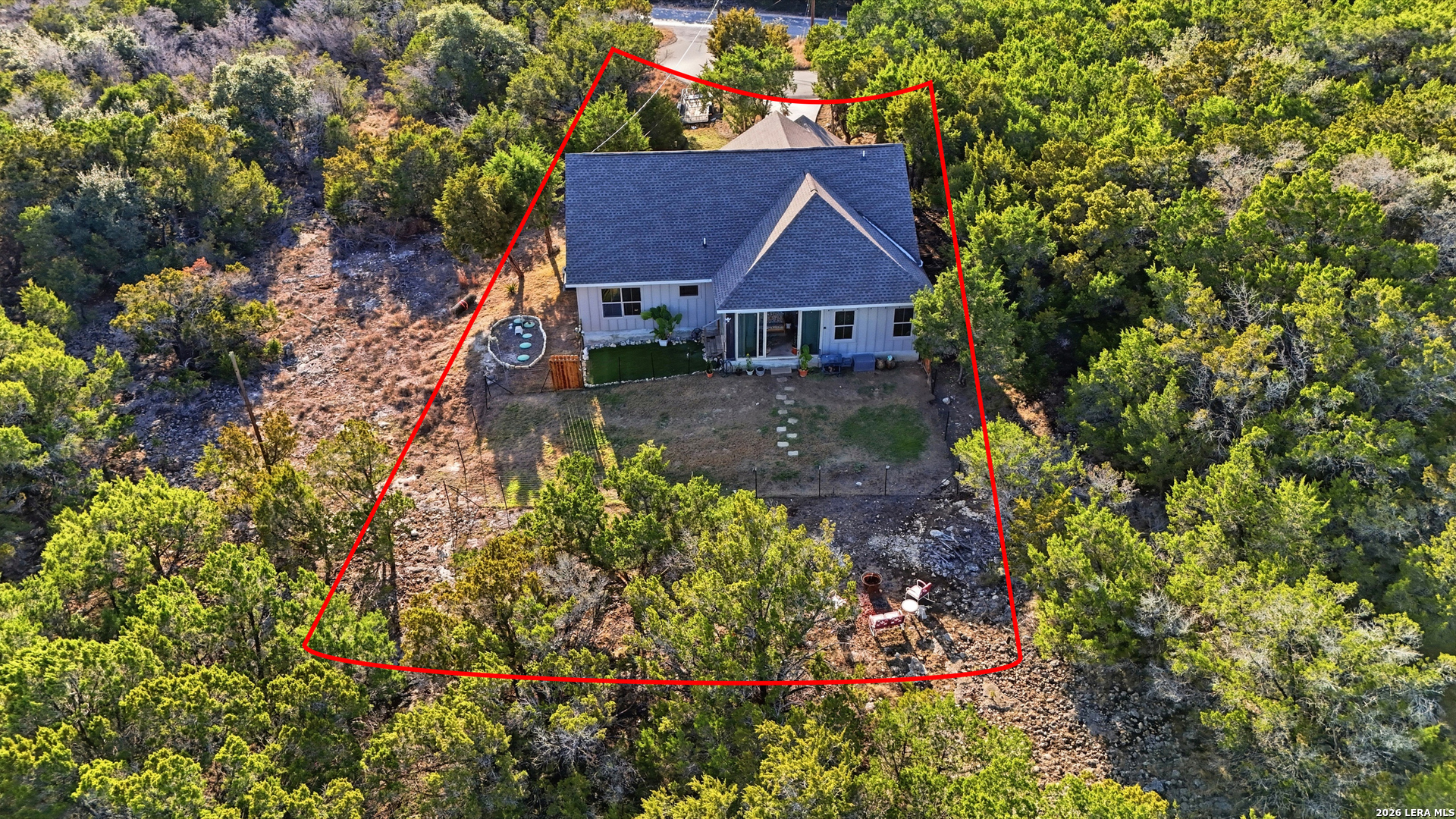 2295 Tanglewood Trail Spring Branch, TX 78070 - Photo 34 of 37 a view of a house with a small yard and plants