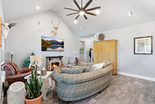 a living room with furniture a fireplace and a flat screen tv