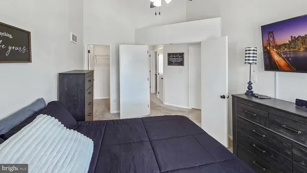 a bedroom with a bed and a dresser