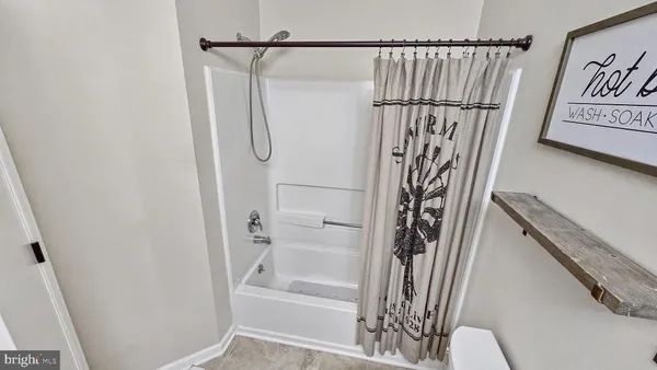 a bathroom with a shower and a glass door