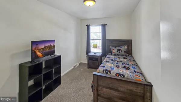 a bedroom with furniture and a flat screen tv