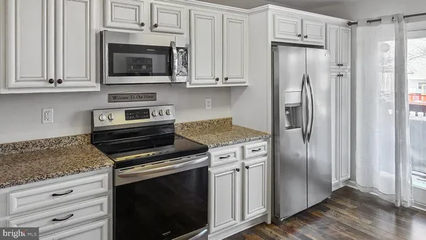 a kitchen with stainless steel appliances wooden cabinets and a stove top oven