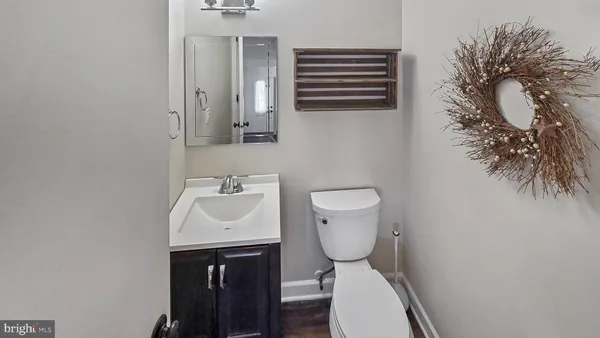 a bathroom with a sink toilet and a mirror