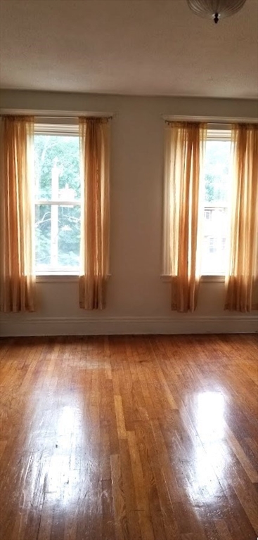 a view of a room with wooden floor and windows