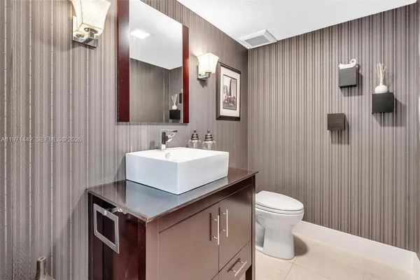 a bathroom with a sink toilet and mirror