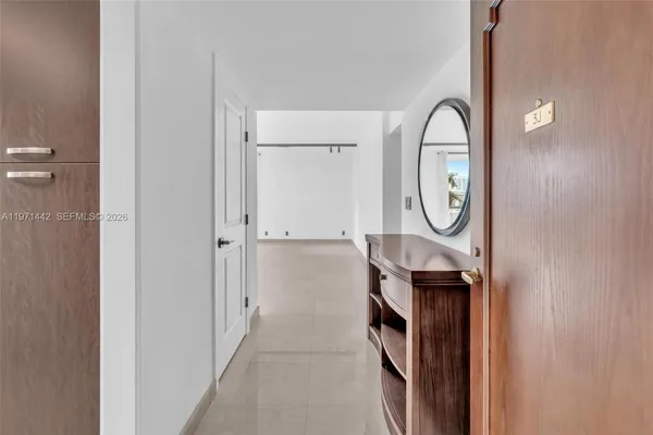 a view of a livingroom with furniture and mirror