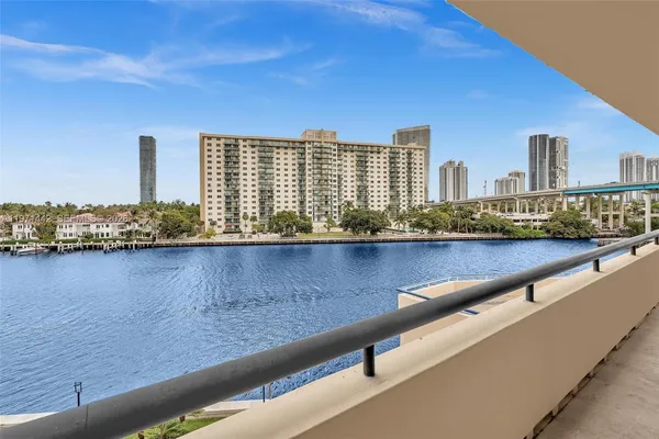 a view of swimming pool with outdoor seating and city view