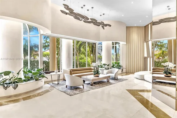 a living room with furniture and large windows