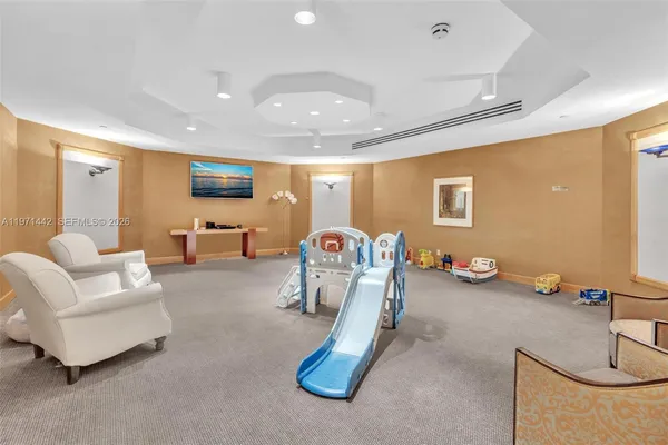 a view of a livingroom with furniture and a flat screen tv