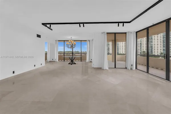 a view of a livingroom with furniture and floor to ceiling window