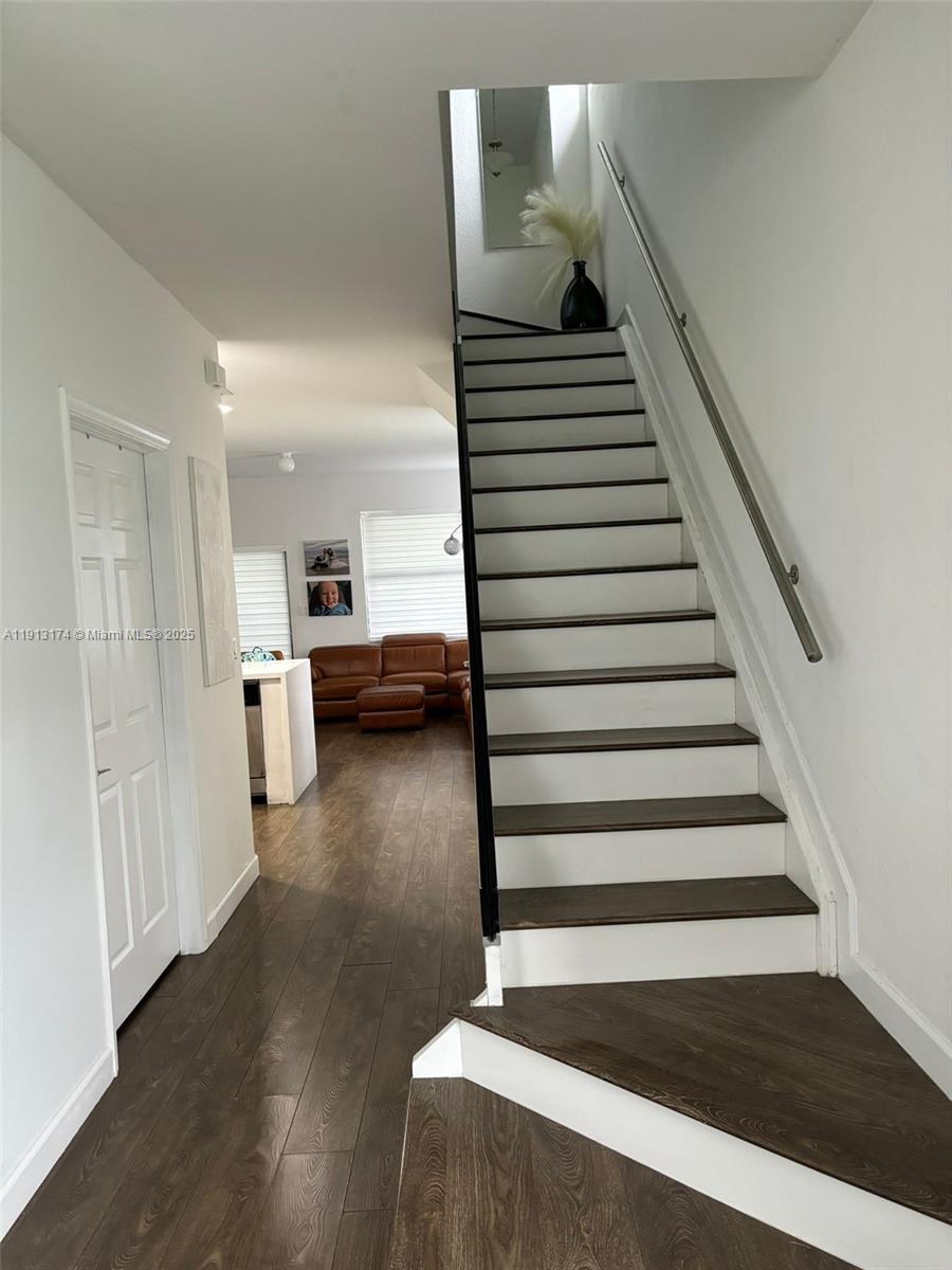 a view of entryway and hall with wooden floor