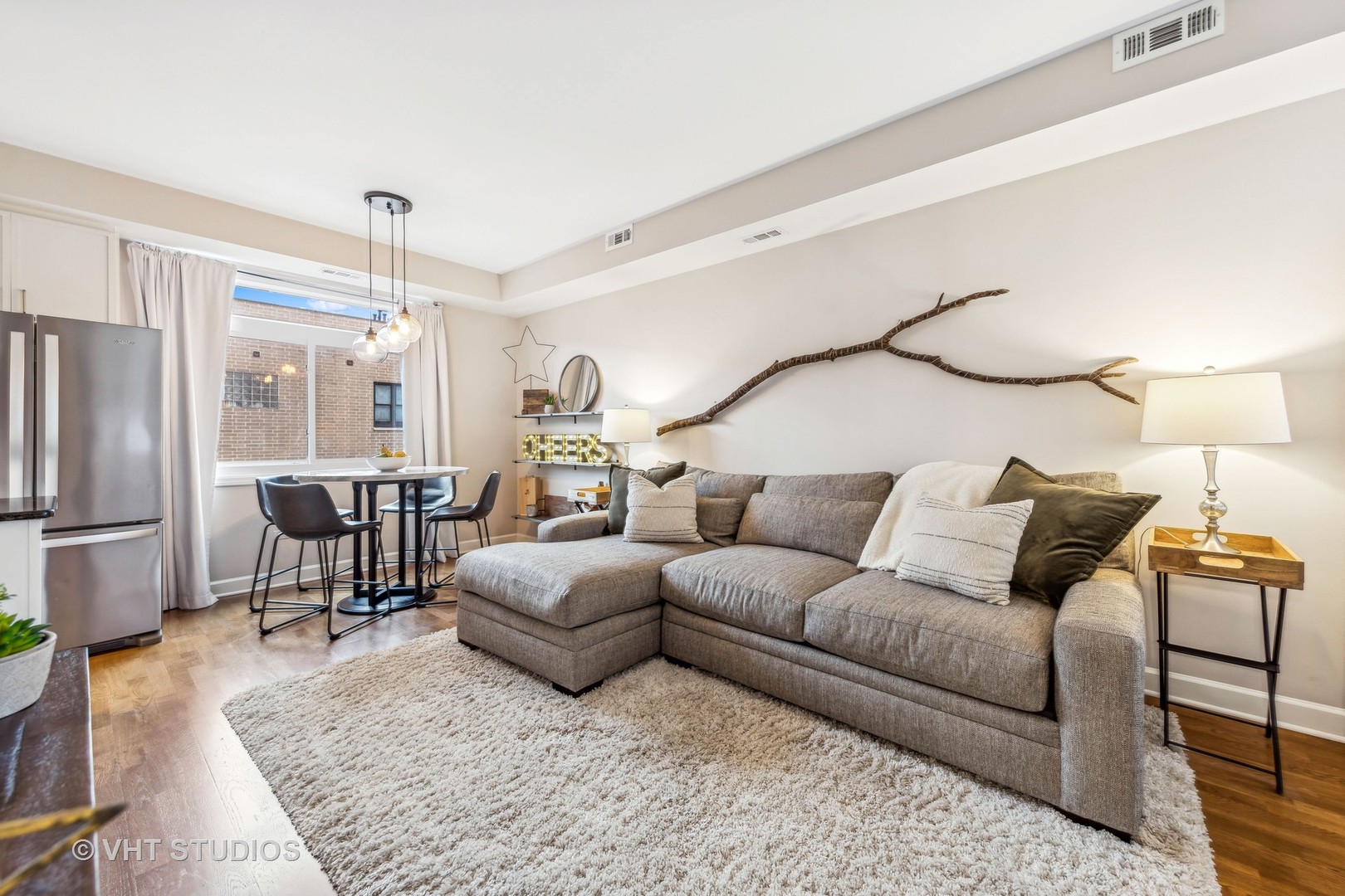 680 North Green Street, Unit 413 Chicago, IL 60642 - Photo 6 of 12 a living room with furniture and a refrigerator