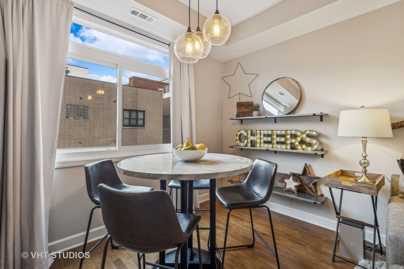 680 North Green Street, Unit 413 Chicago, IL 60642 - Photo 8 of 12 a view of a dining room with furniture a chandelier and wooden floor