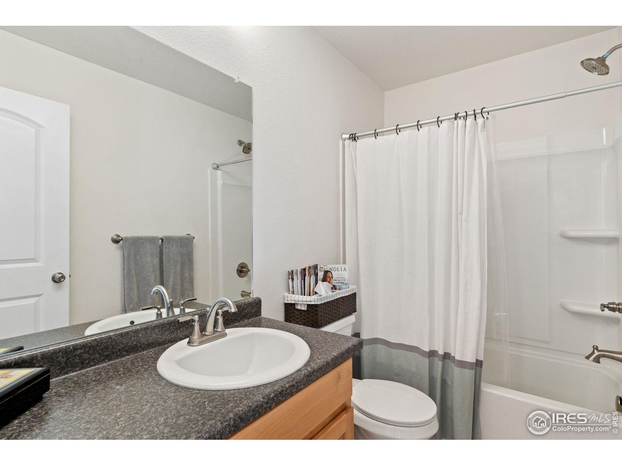 2004 Thundercloud Drive Windsor, CO 80550 - Photo 12 of 24 a bathroom with a sink and a mirror