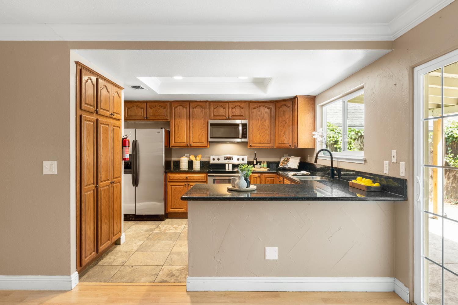 8930 Genoa Avenue Orangevale, CA 95662 - Photo 13 of 46 a kitchen with stainless steel appliances granite countertop a sink a stove and a refrigerator