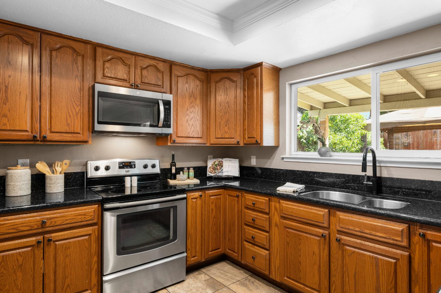 8930 Genoa Avenue Orangevale, CA 95662 - Photo 14 of 46 a kitchen with granite countertop cabinets stainless steel appliances a sink and window
