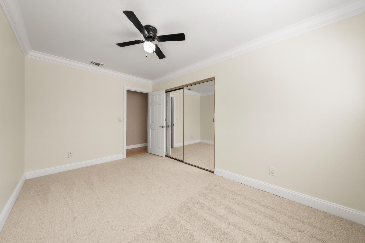 8930 Genoa Avenue Orangevale, CA 95662 - Photo 17 of 46 an empty room with closet and ceiling fan