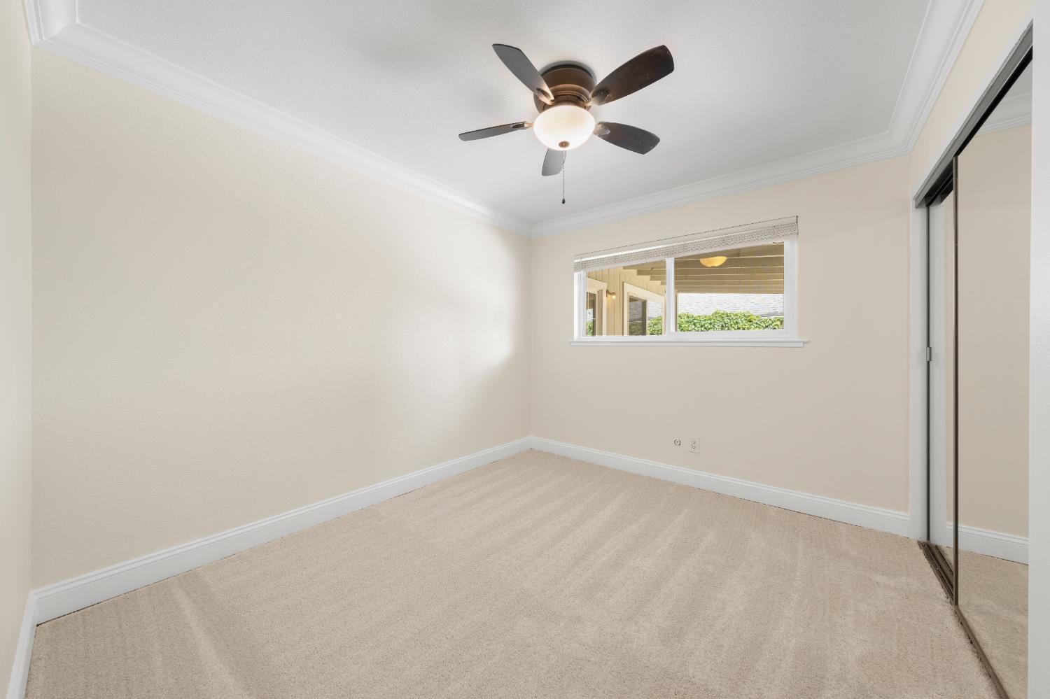 8930 Genoa Avenue Orangevale, CA 95662 - Photo 18 of 46 an empty room with a window and a ceiling fan
